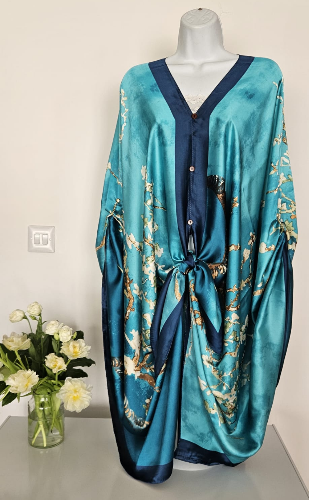 handmade boho-style multi-wear kaftan coloured with cherry blossom turquoise, with navy blue and botanical, made from a soft cotton-polyester blend  
