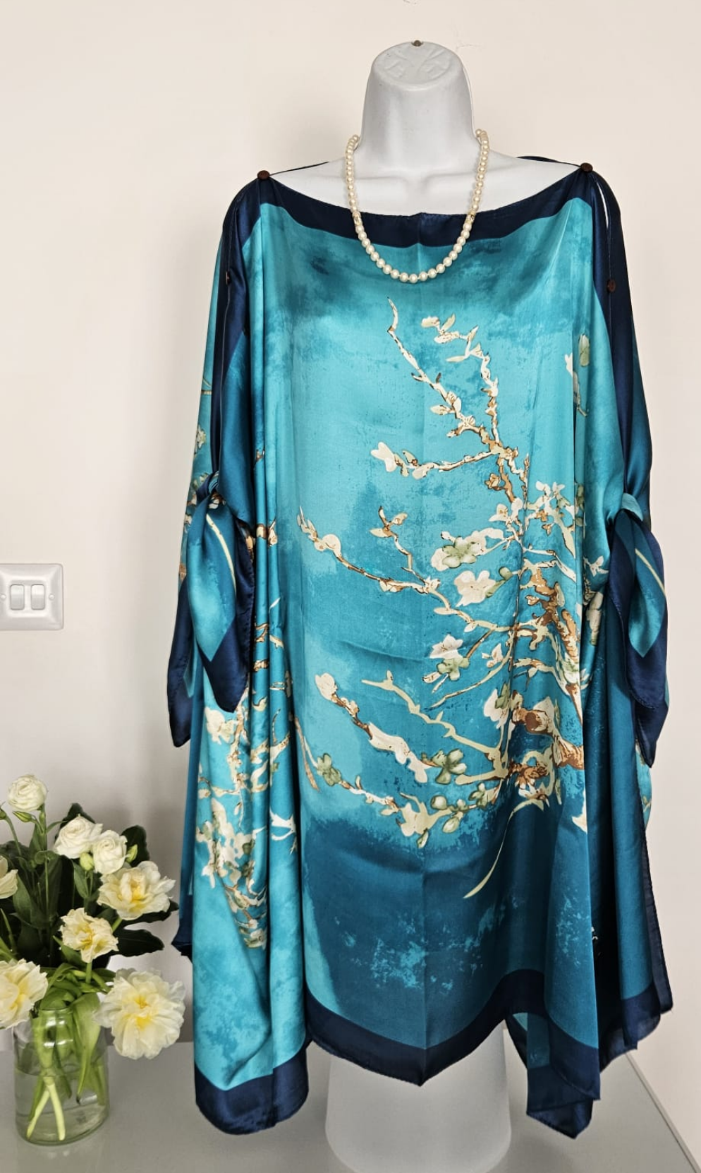 handmade boho-style multi-wear kaftan coloured with cherry blossom turquoise, with navy blue and botanical, made from a soft cotton-polyester blend  