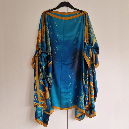 Handmade Boho-style multi-wear kaftan and robe in turquoise with golden border and botanical cherry blossom print, made from a soft cotton-polyester blend