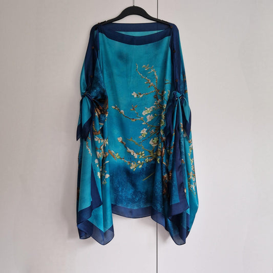 handmade boho-style multi-wear kaftan coloured with cherry blossom turquoise, with navy blue and botanical, made from a soft cotton-polyester blend  