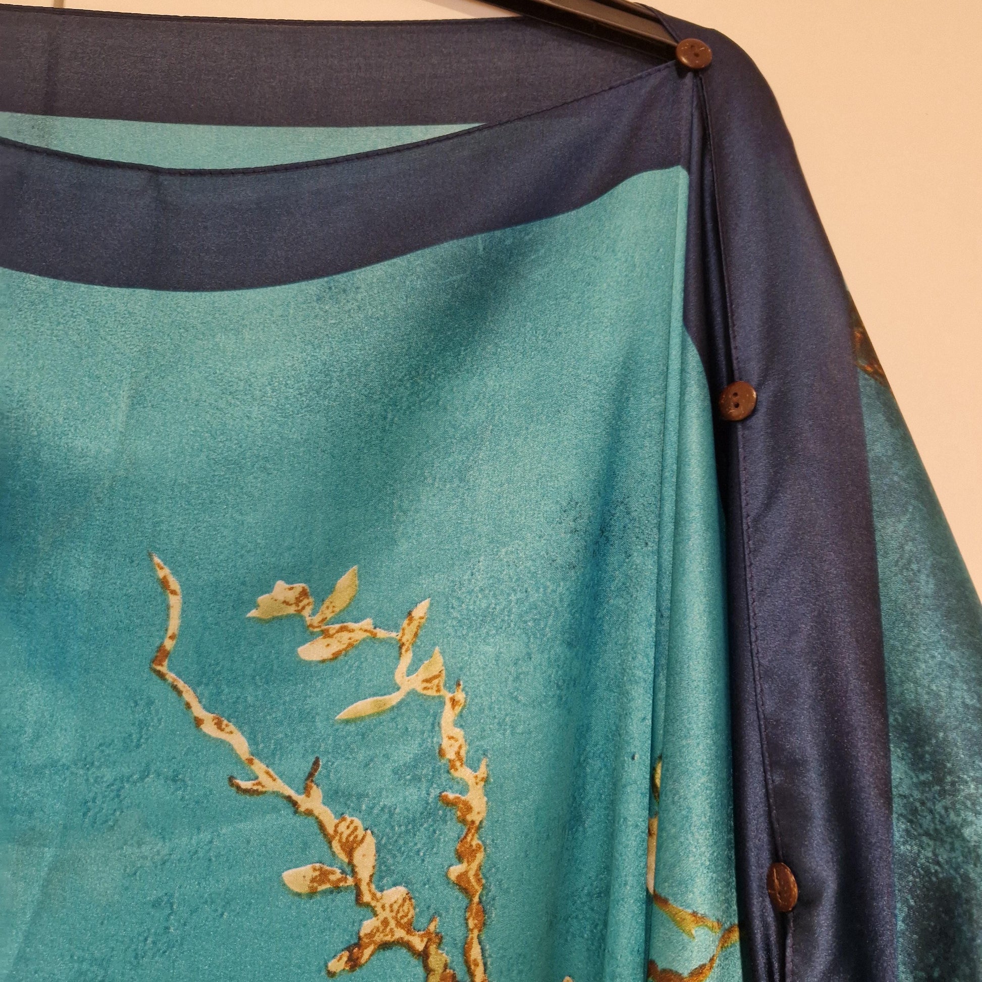 handmade boho-style multi-wear kaftan coloured with cherry blossom turquoise, with navy blue and botanical, made from a soft cotton-polyester blend    