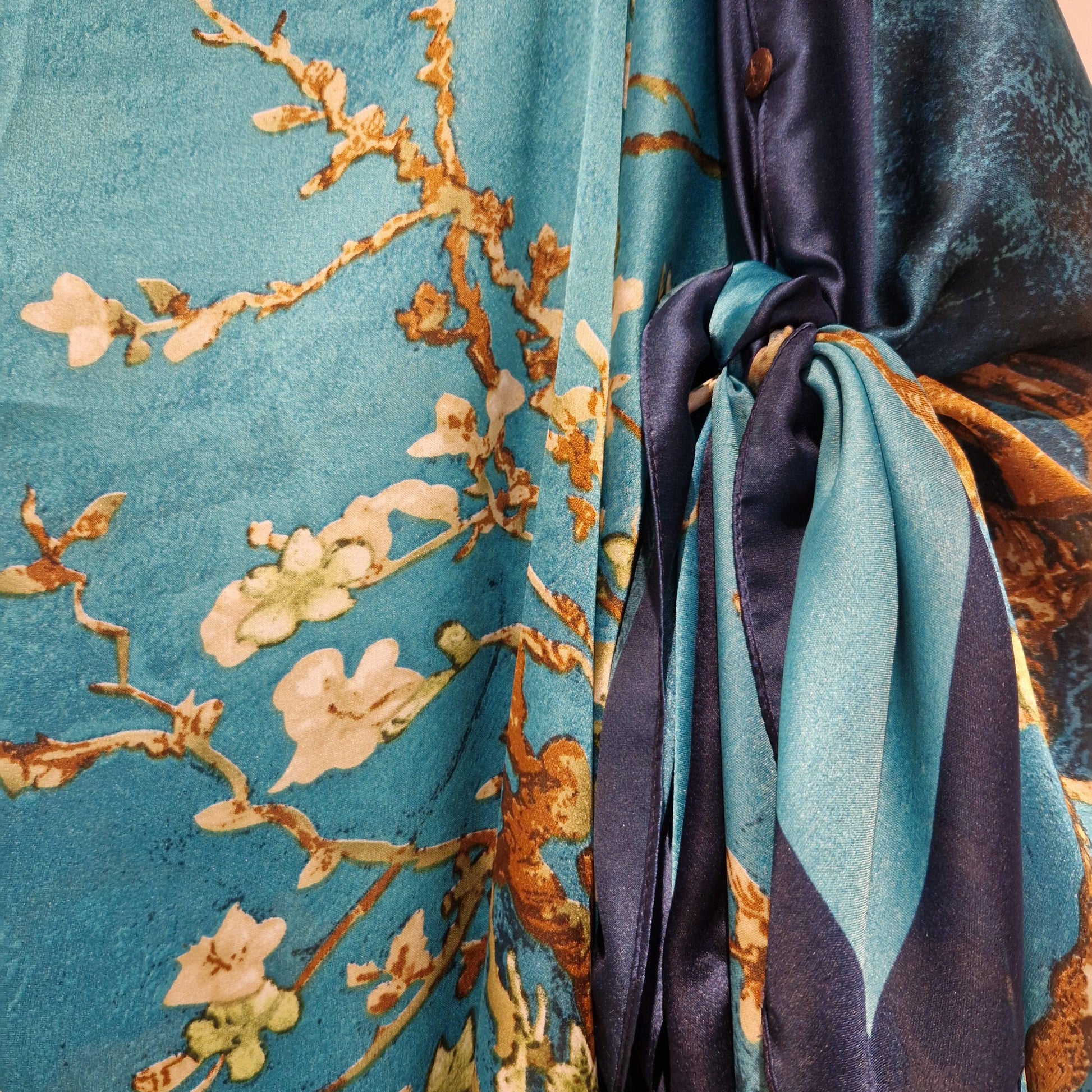 handmade boho-style multi-wear kaftan coloured with cherry blossom turquoise, with navy blue and botanical, made from a soft cotton-polyester blend  