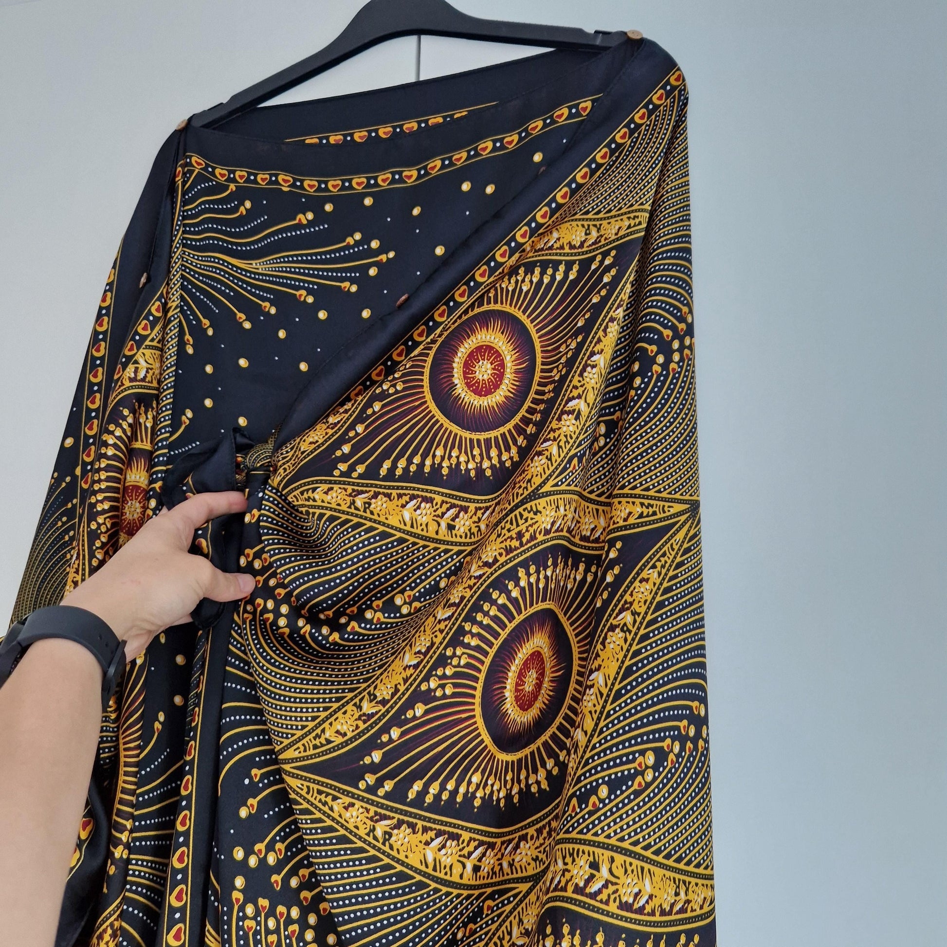 Handmade Boho-style multi-wear kaftan,  black robe, and gold details with botanicals are made from a soft cotton-polyester blend.