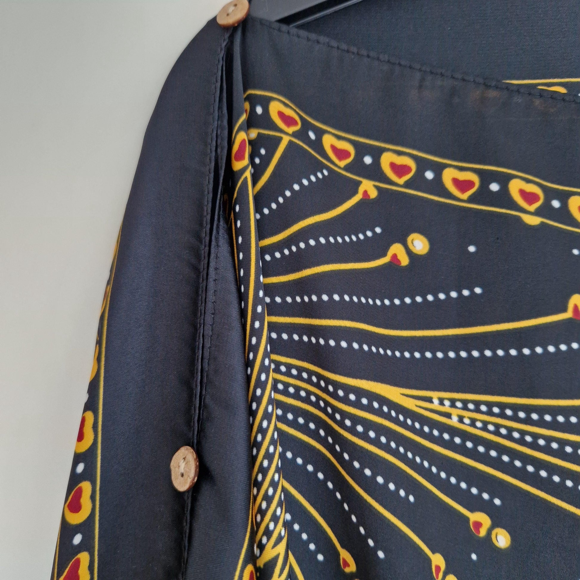 Handmade Boho-style multi-wear kaftan,  black robe, and gold details with botanicals are made from a soft cotton-polyester blend.