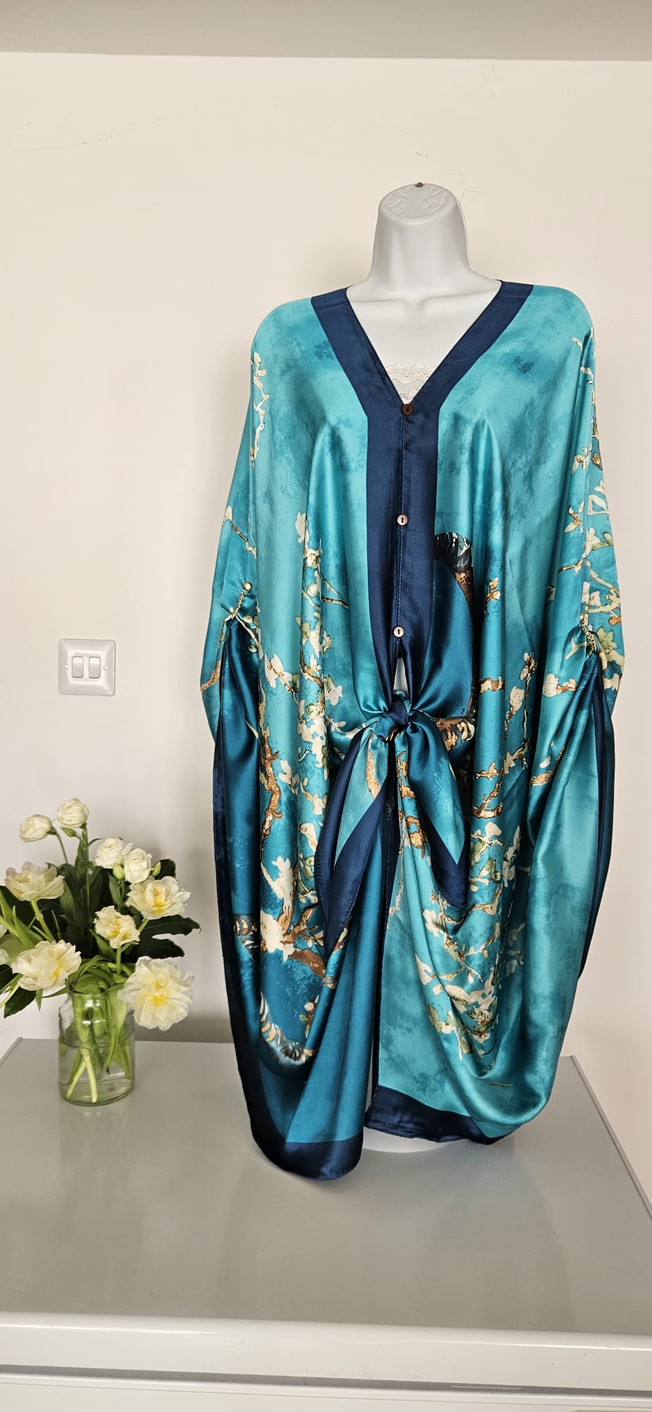 handmade boho-style multi-wear kaftan coloured with cherry blossom turquoise, with navy blue and botanical, made from a soft cotton-polyester blend  